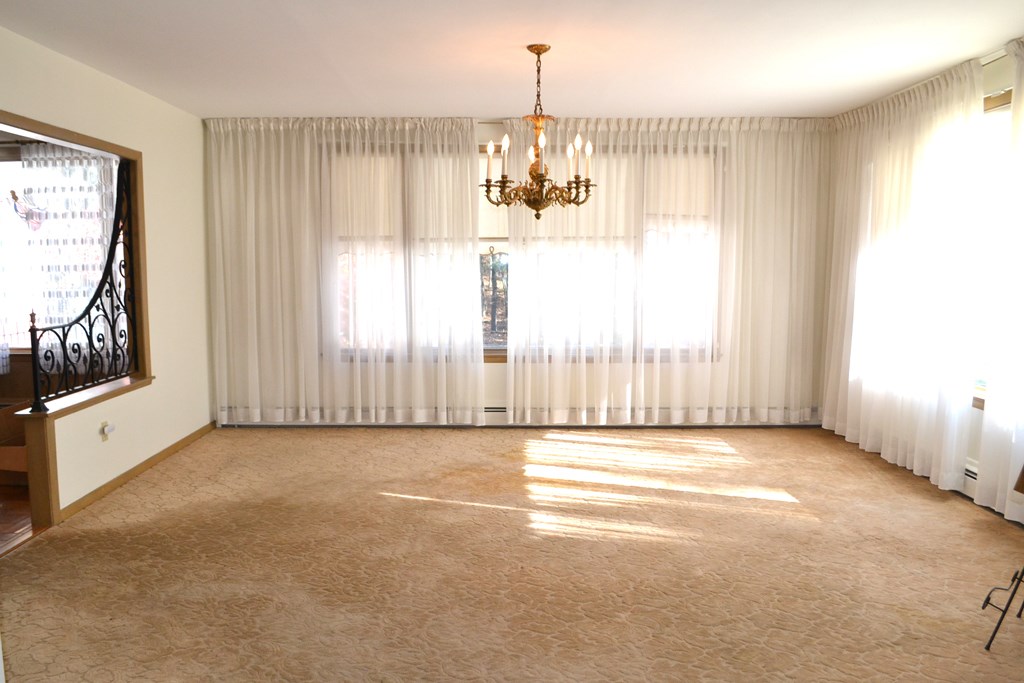 328 Angell Road Lincoln, RI 02865 - Photo 8 of 38 Dining room open to living room, with corner windows and views of woods