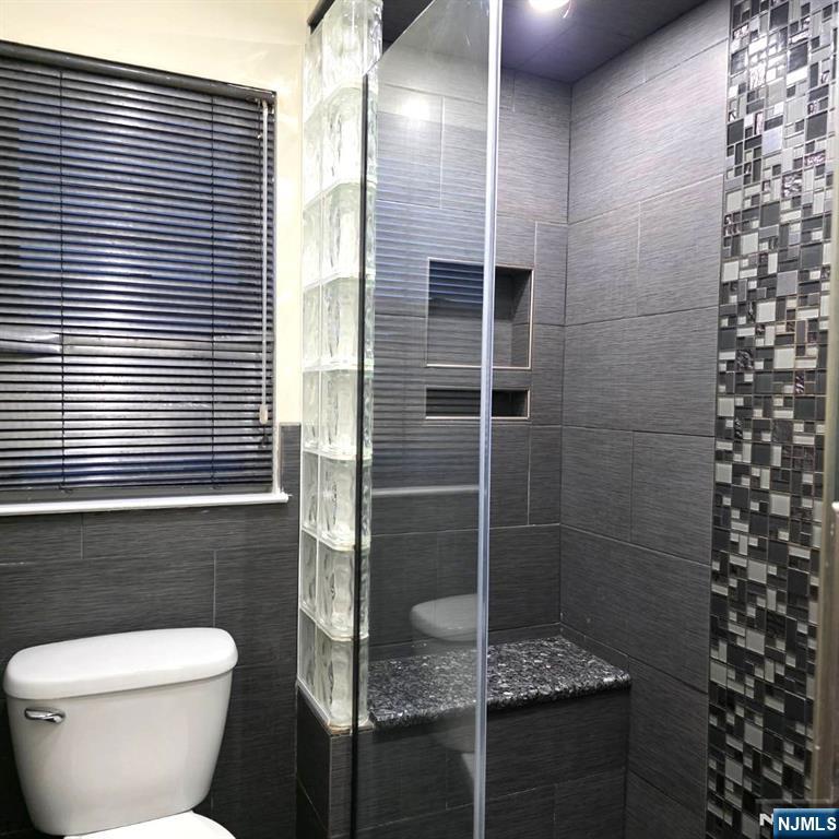 24 Van Vechten Street, Unit 2 Newark, NJ 07114 - Photo 15 of 36 a bathroom with a shower and a toilet