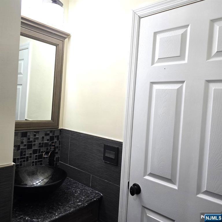 24 Van Vechten Street, Unit 2 Newark, NJ 07114 - Photo 18 of 36 a bathroom with a sink and a mirror