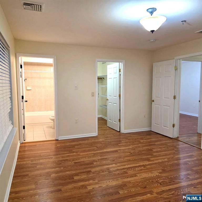 24 Van Vechten Street, Unit 2 Newark, NJ 07114 - Photo 20 of 36 an empty room with wooden floor and cabinet