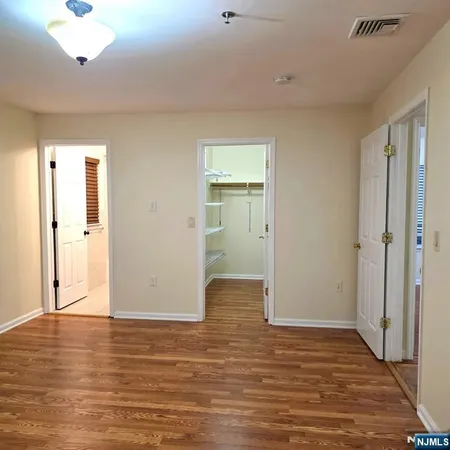 a view of an empty room and wooden floor