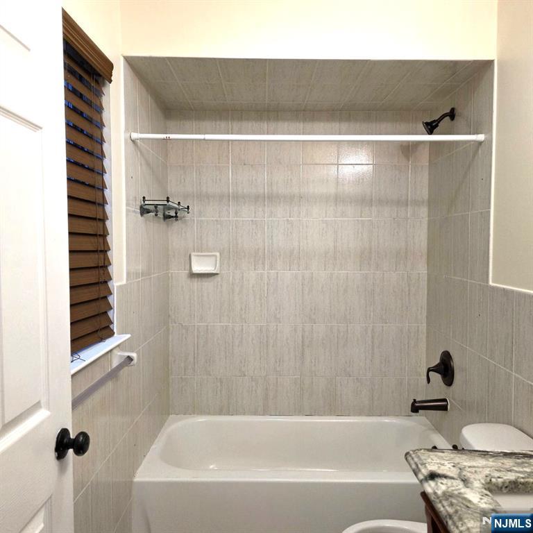 24 Van Vechten Street, Unit 2 Newark, NJ 07114 - Photo 22 of 36 a bathroom with a bathtub and a shower