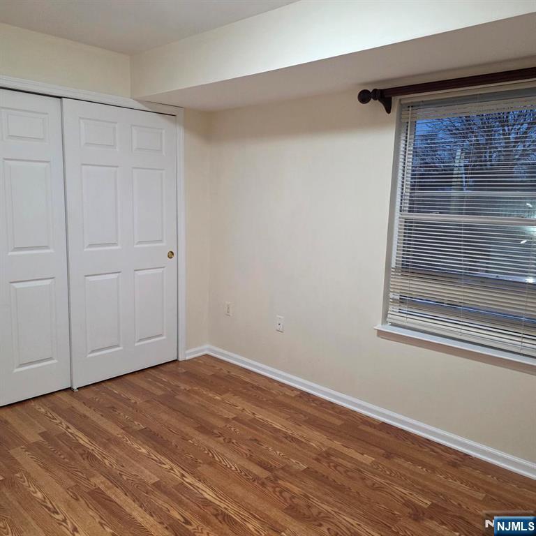24 Van Vechten Street, Unit 2 Newark, NJ 07114 - Photo 27 of 36 an empty room with wooden floor and windows