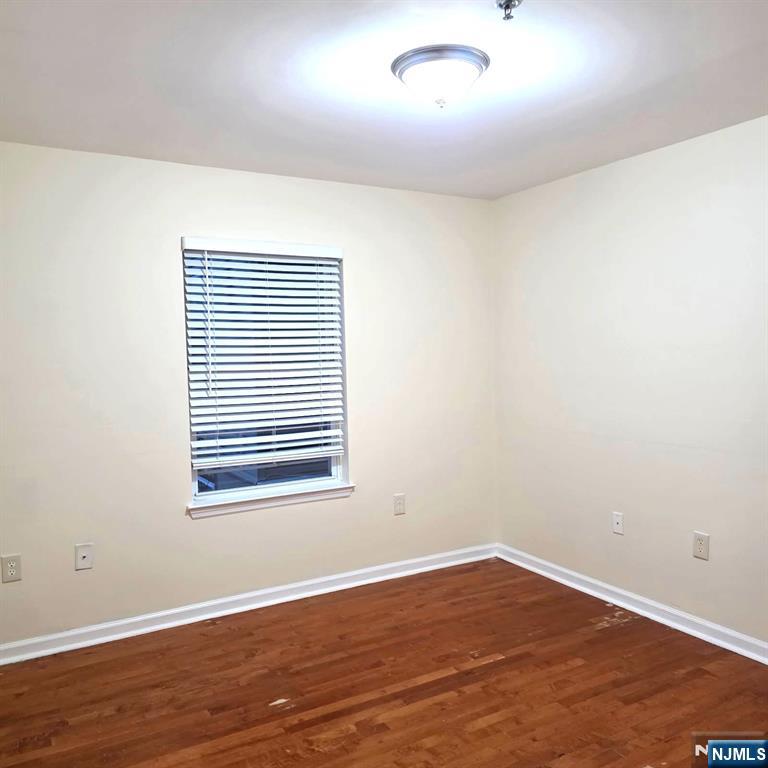 24 Van Vechten Street, Unit 2 Newark, NJ 07114 - Photo 31 of 36 an empty room with wooden floor and windows