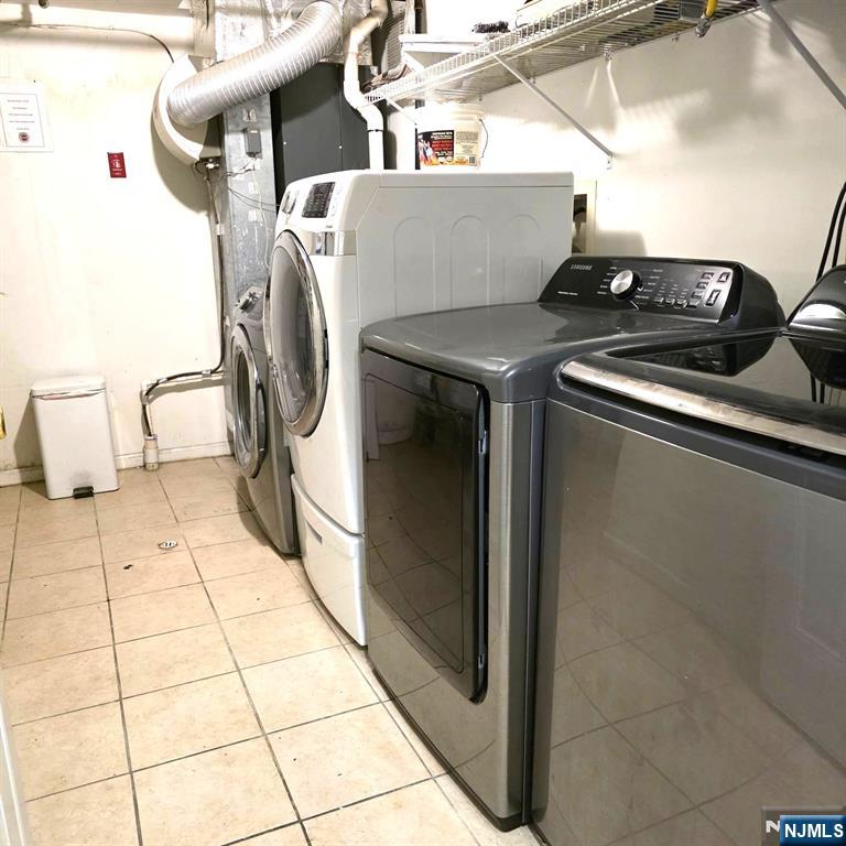 24 Van Vechten Street, Unit 2 Newark, NJ 07114 - Photo 34 of 36 a utility room with dryer and washer