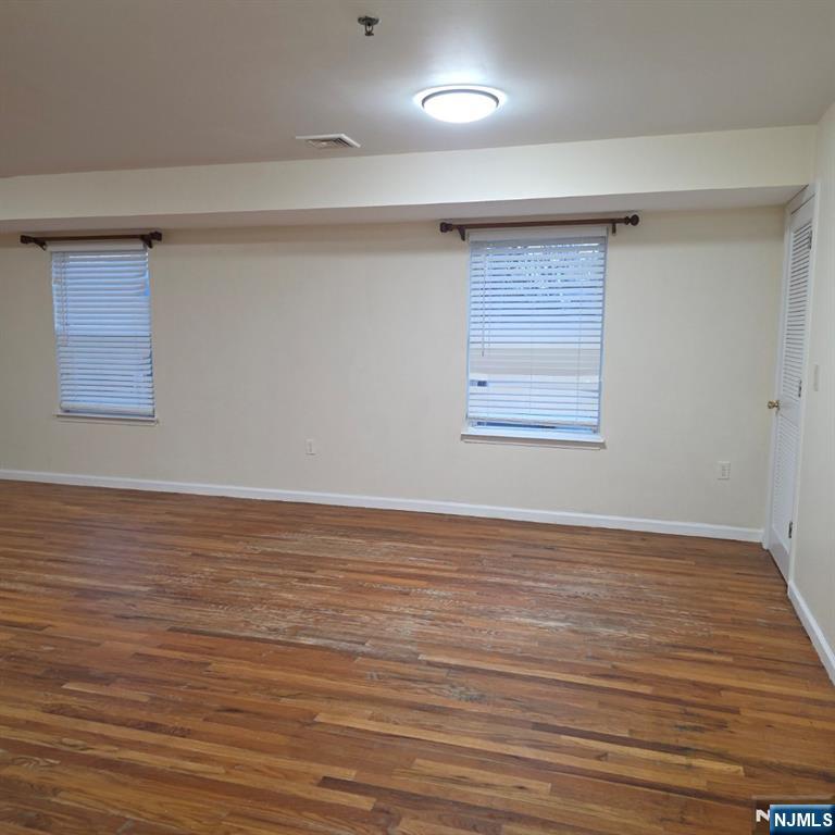 24 Van Vechten Street, Unit 2 Newark, NJ 07114 - Photo 9 of 36 a view of an empty room with wooden floor and a window