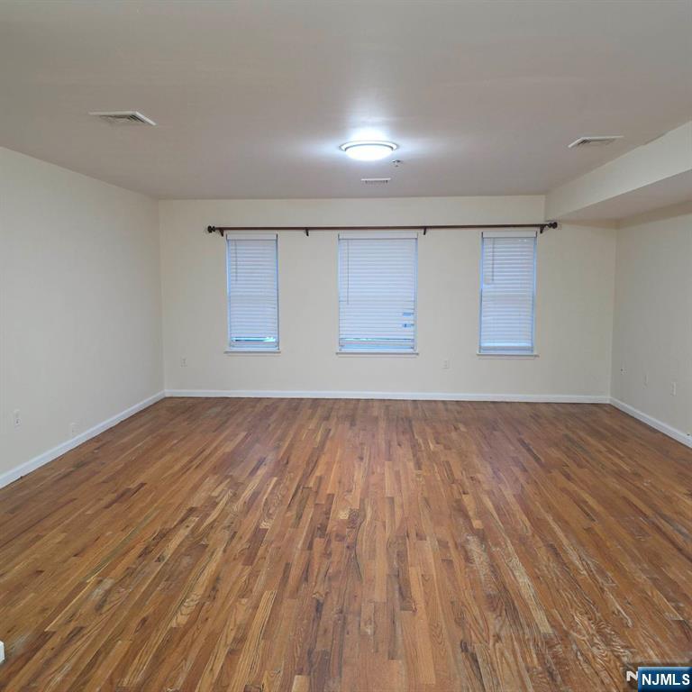 24 Van Vechten Street, Unit 2 Newark, NJ 07114 - Photo 10 of 36 a view of empty room with wooden floor and fan