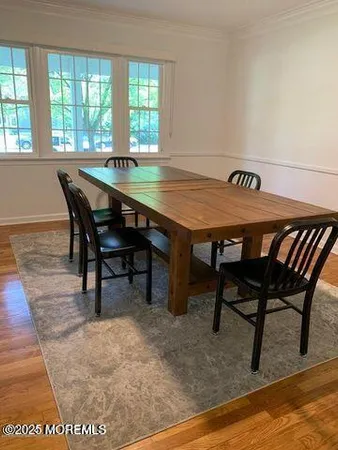 a view of a dining room with furniture and window