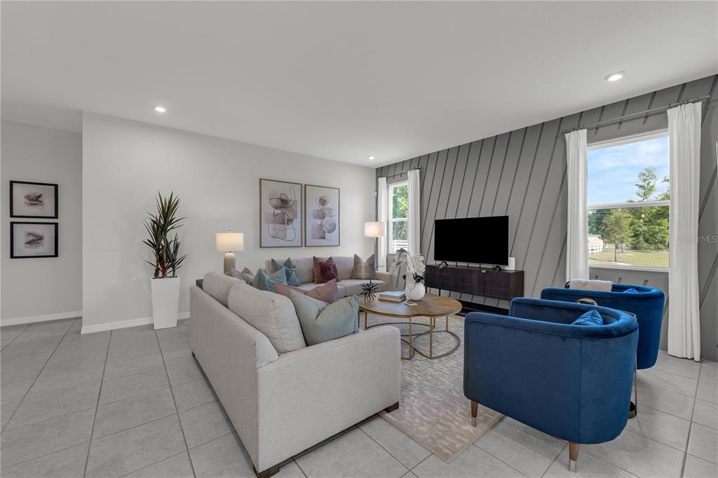 1267 Blue Daze Lane Eustis, FL 32726 - Photo 12 of 34 a living room with furniture and a flat screen tv