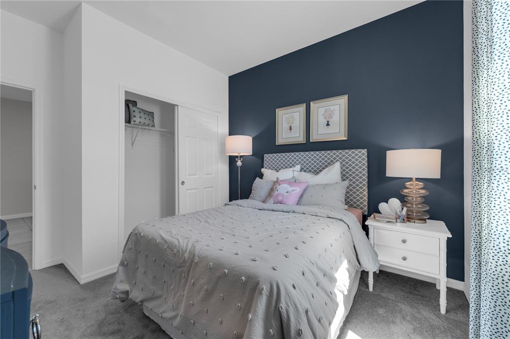 1267 Blue Daze Lane Eustis, FL 32726 - Photo 20 of 34 a bedroom with a bed and a night stand