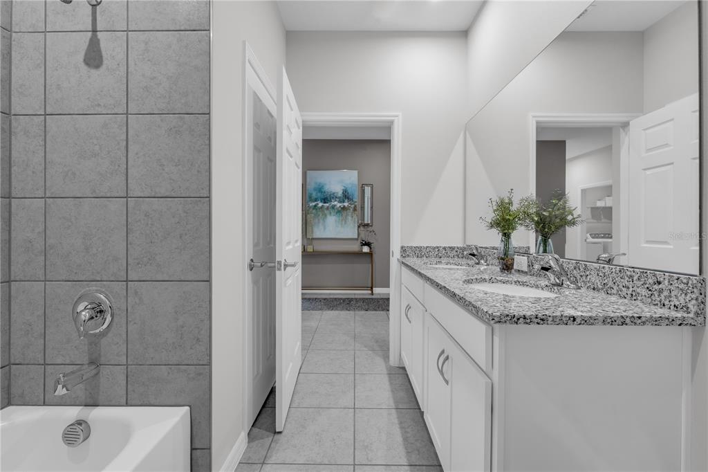 1267 Blue Daze Lane Eustis, FL 32726 - Photo 25 of 34 a bathroom with a granite countertop sink a toilet and shower
