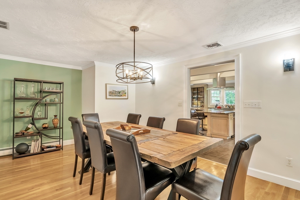 10 Ballard Terrace Lexington, MA 02420 - Photo 13 of 42 a view of a dining room with furniture wooden floor and chandelier