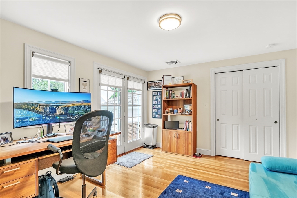 10 Ballard Terrace Lexington, MA 02420 - Photo 22 of 42 a view of a workspace with furniture and a bookshelf