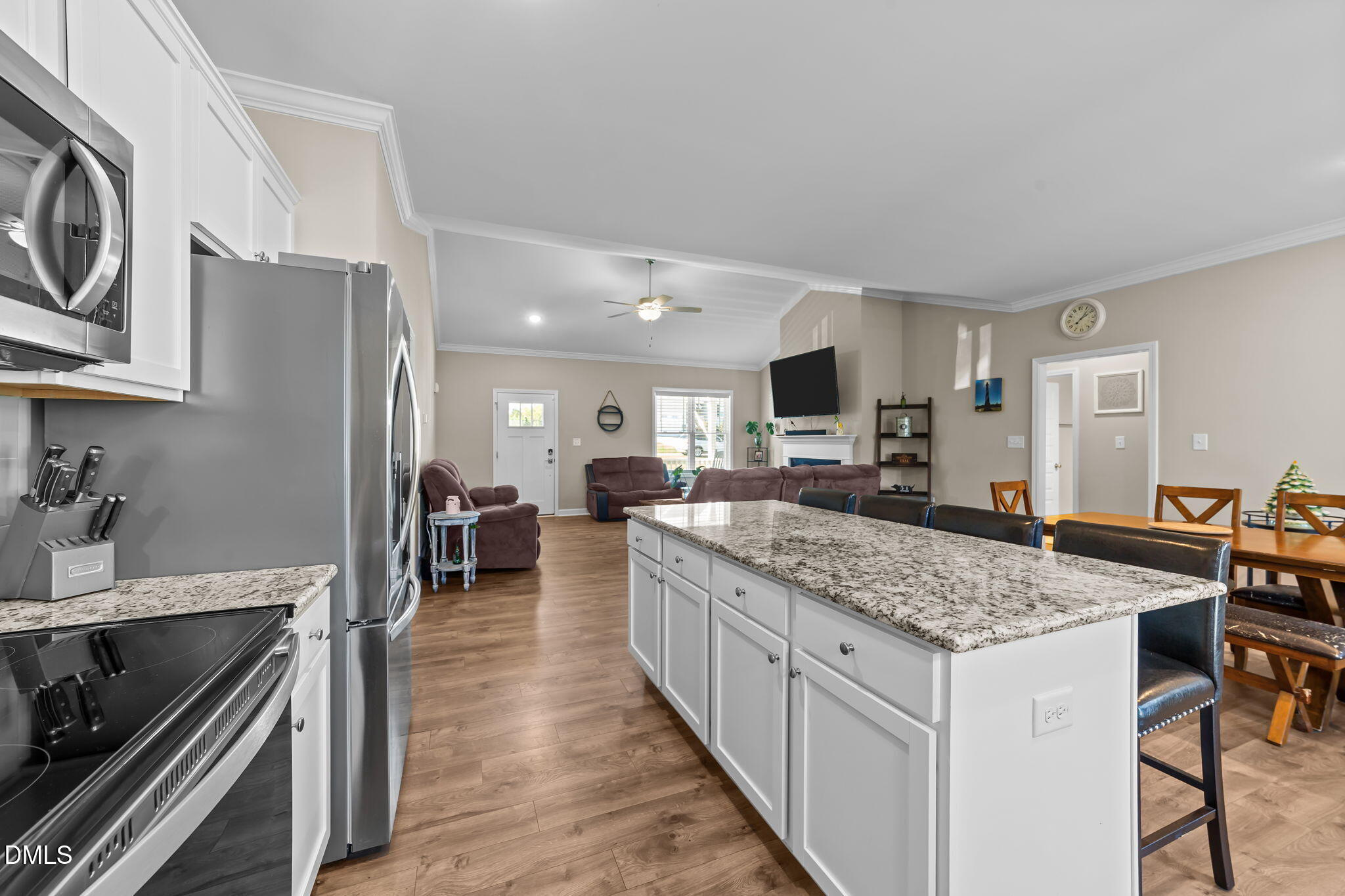 73 Rabbit Run Drive Smithfield, NC 27577 - Photo 11 of 46 a kitchen with stainless steel appliances granite countertop a stove top oven a sink dishwasher and a refrigerator with wooden floor