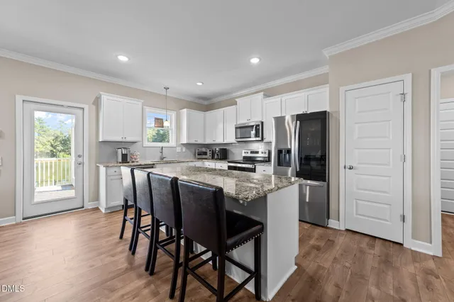 a kitchen with appliances a sink a counter top space and cabinets