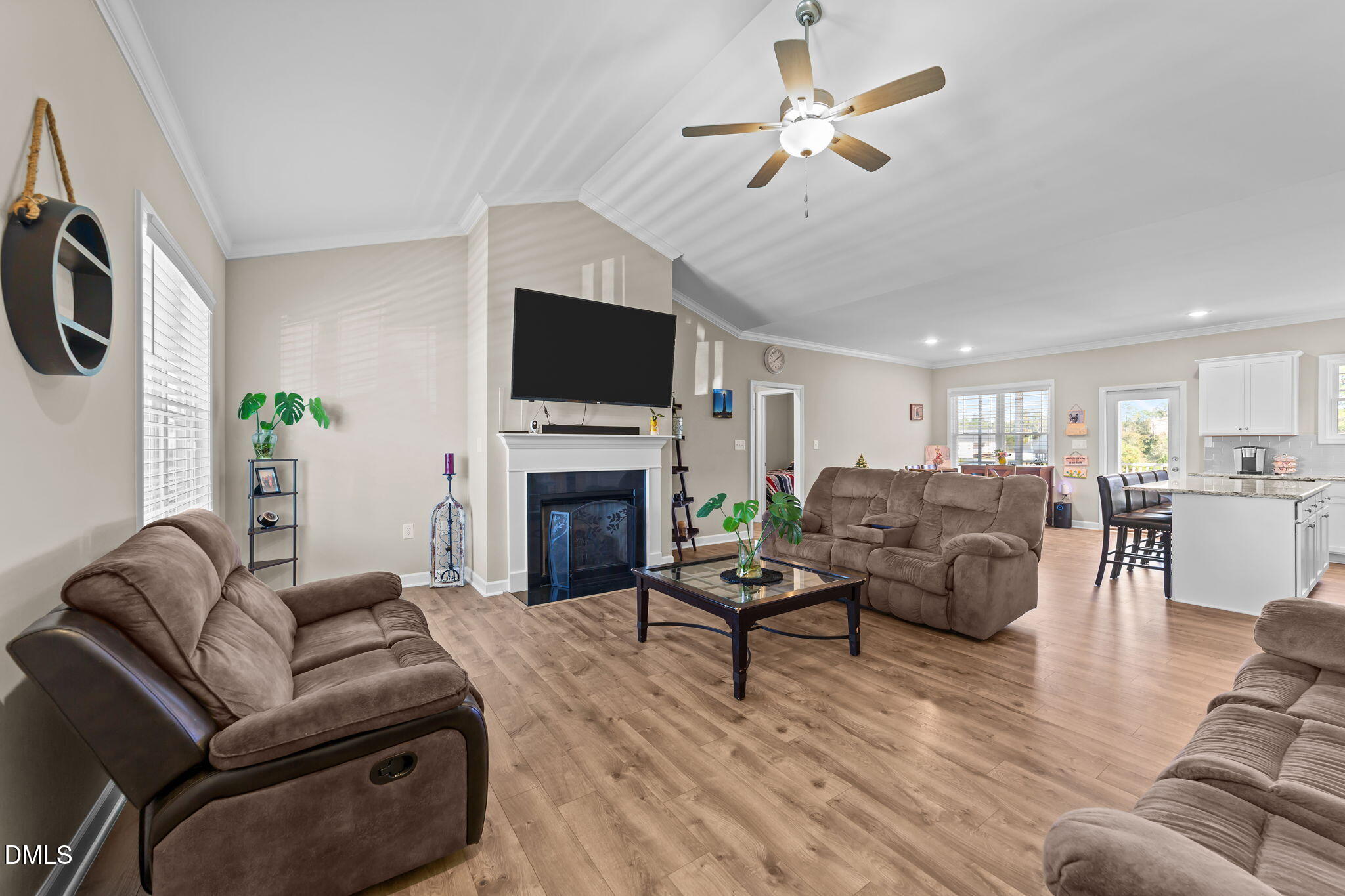 73 Rabbit Run Drive Smithfield, NC 27577 - Photo 16 of 46 a living room with furniture a fireplace and a flat screen tv