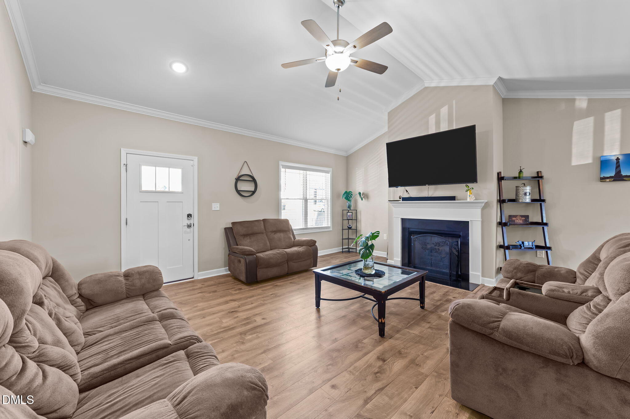 73 Rabbit Run Drive Smithfield, NC 27577 - Photo 17 of 46 a living room with furniture a fireplace and a flat screen tv