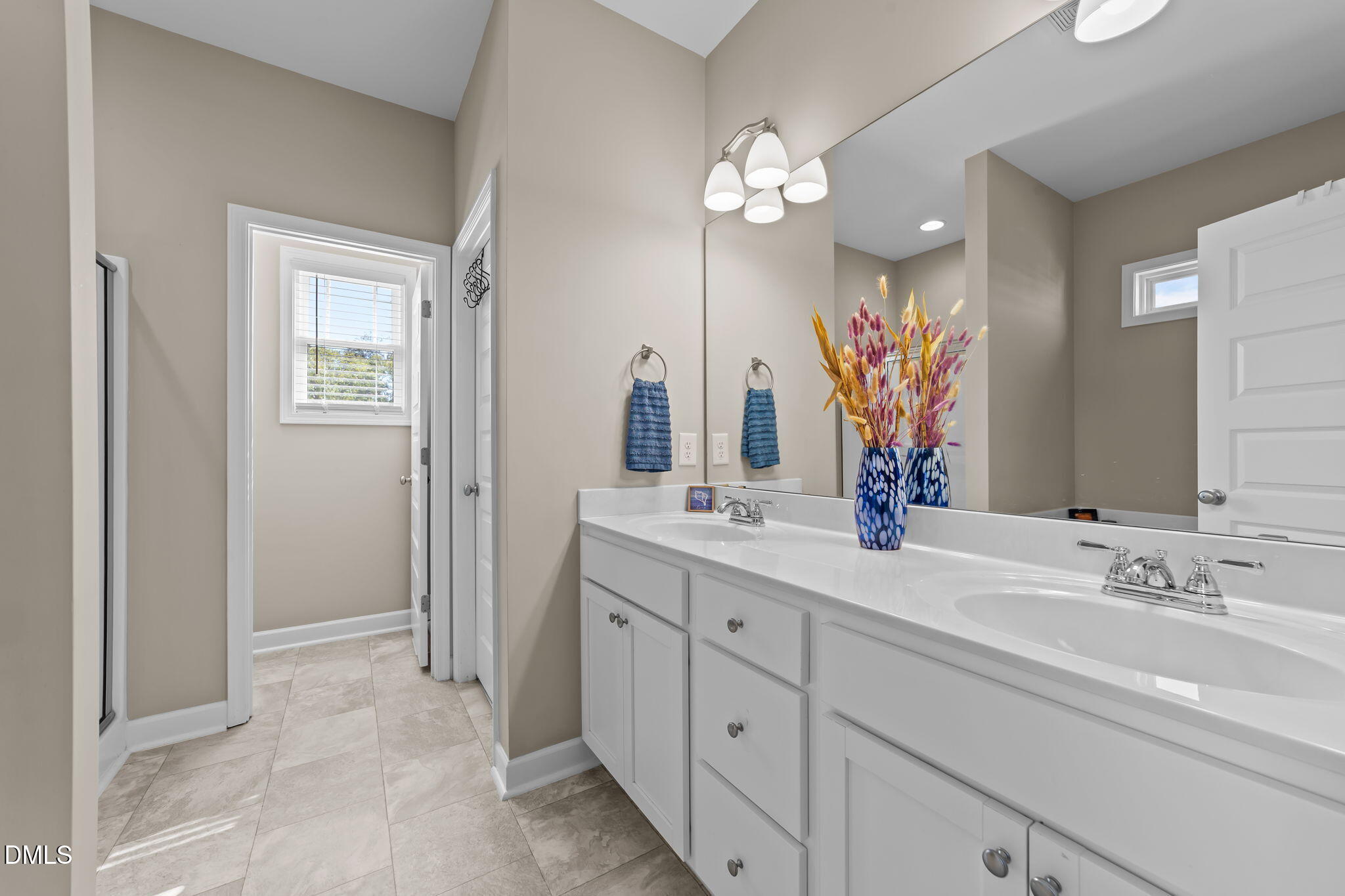 73 Rabbit Run Drive Smithfield, NC 27577 - Photo 23 of 46 a bathroom with a double vanity sink mirror and next to a window