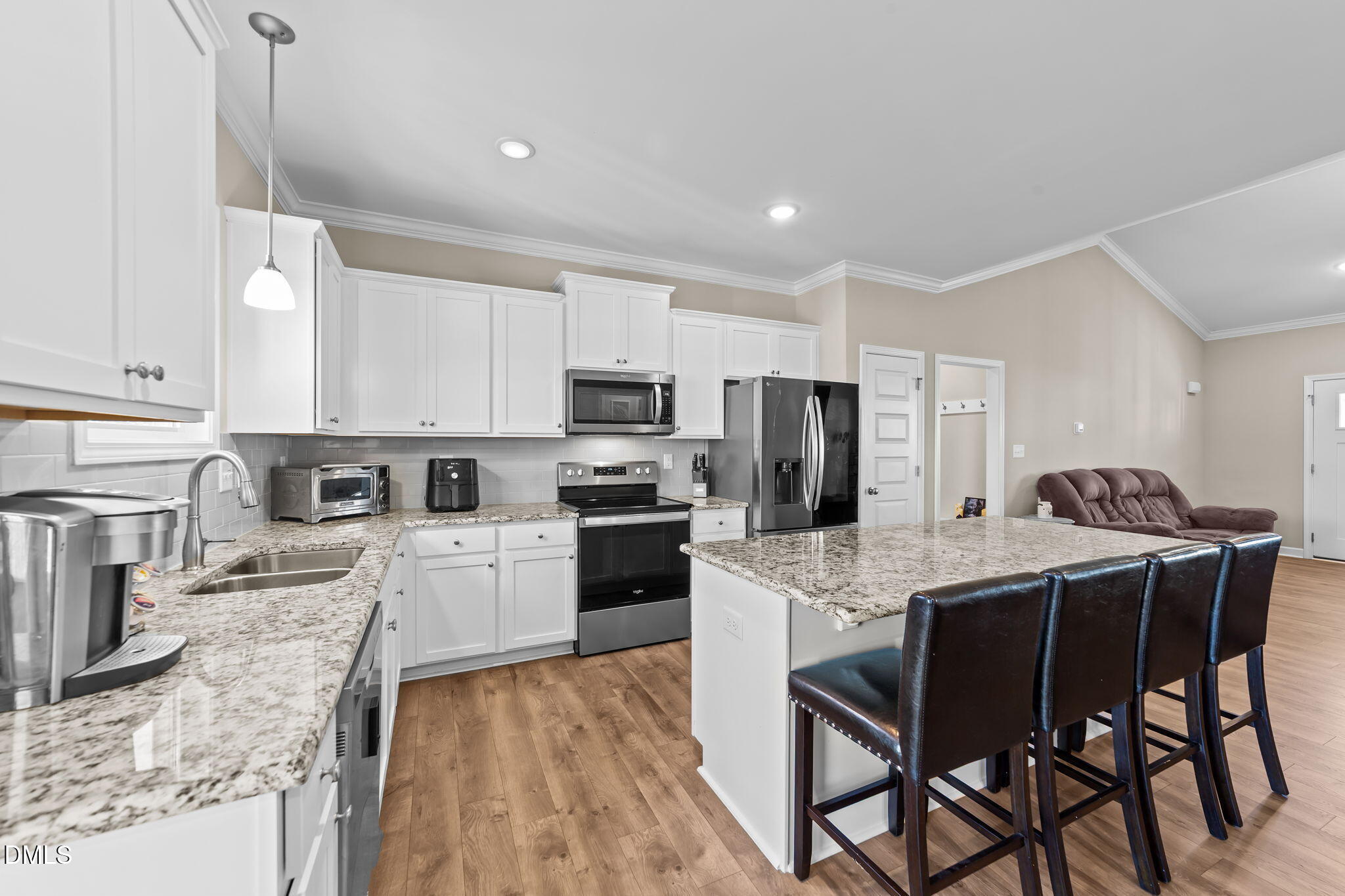 73 Rabbit Run Drive Smithfield, NC 27577 - Photo 9 of 46 a kitchen with stainless steel appliances granite countertop a stove top oven a refrigerator a sink and a dining table with white cabinets
