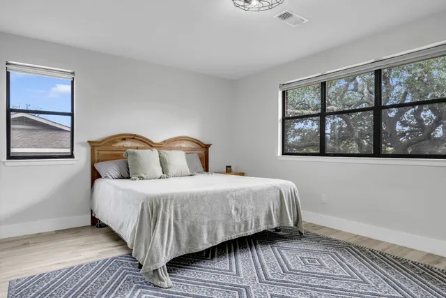 a bedroom with a bed and wooden floor