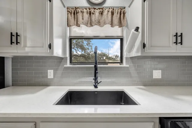a kitchen with a sink and cabinets