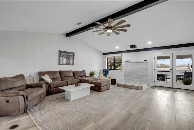 a living room with furniture and wooden floor