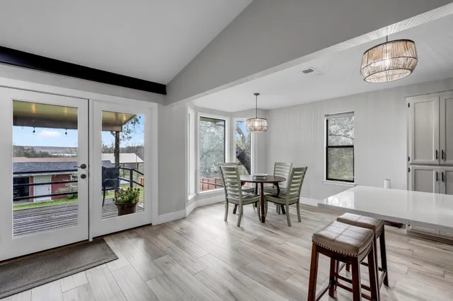 a dining room with furniture and wooden floor
