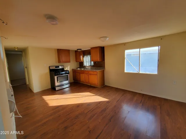 a kitchen with stainless steel appliances granite countertop a stove a sink and a refrigerator