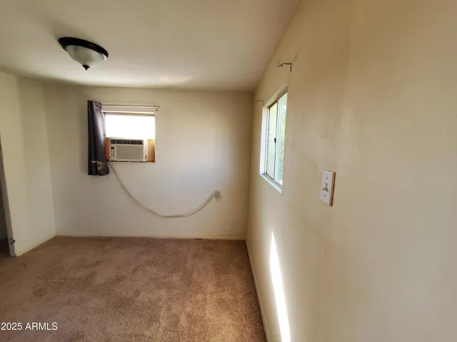 a view of a livingroom with wooden floor and a window