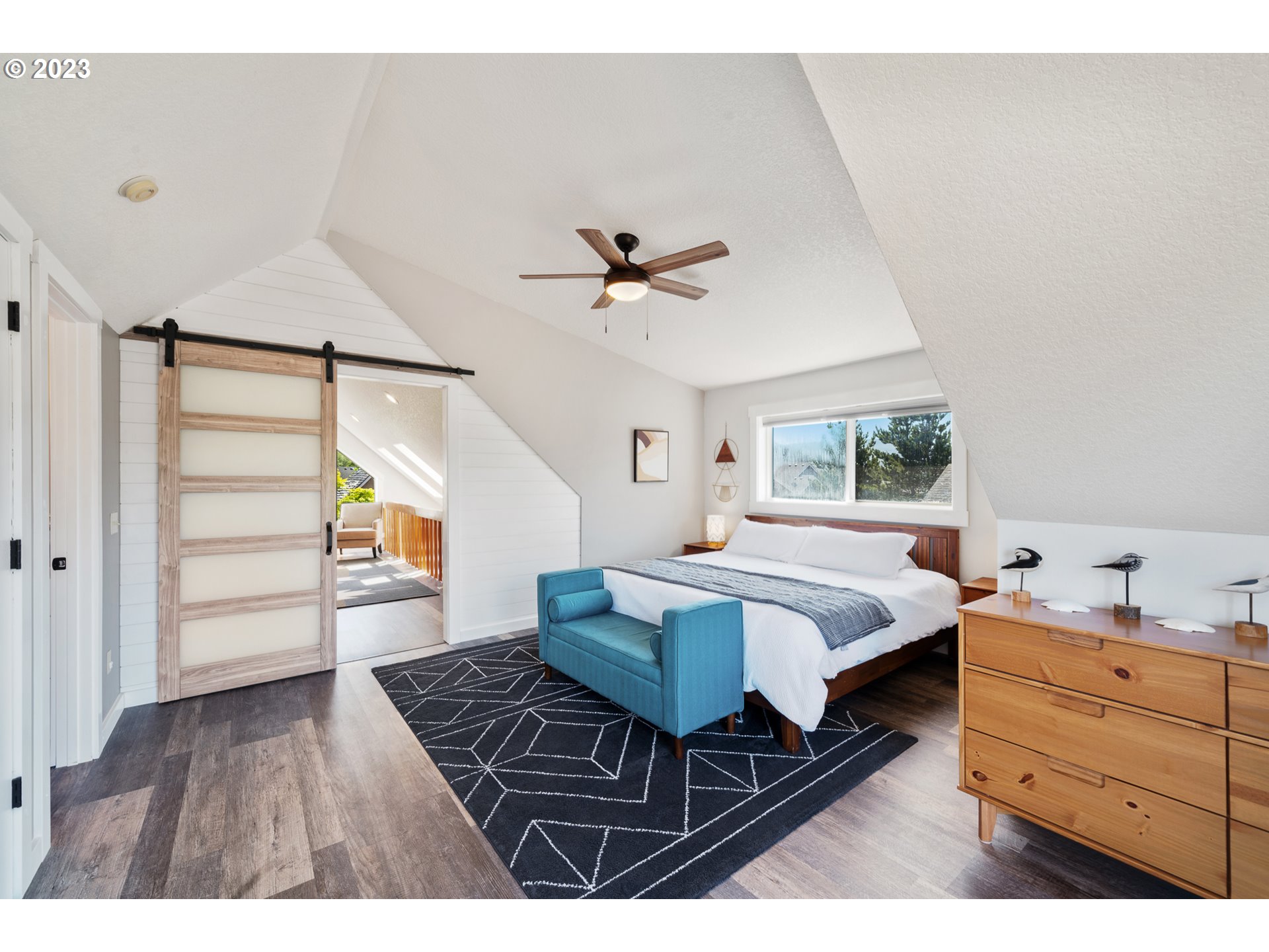 34010 Mallard Avenue Nehalem, OR 97131 - Photo 12 of 25 a spacious bedroom with a bed and a table