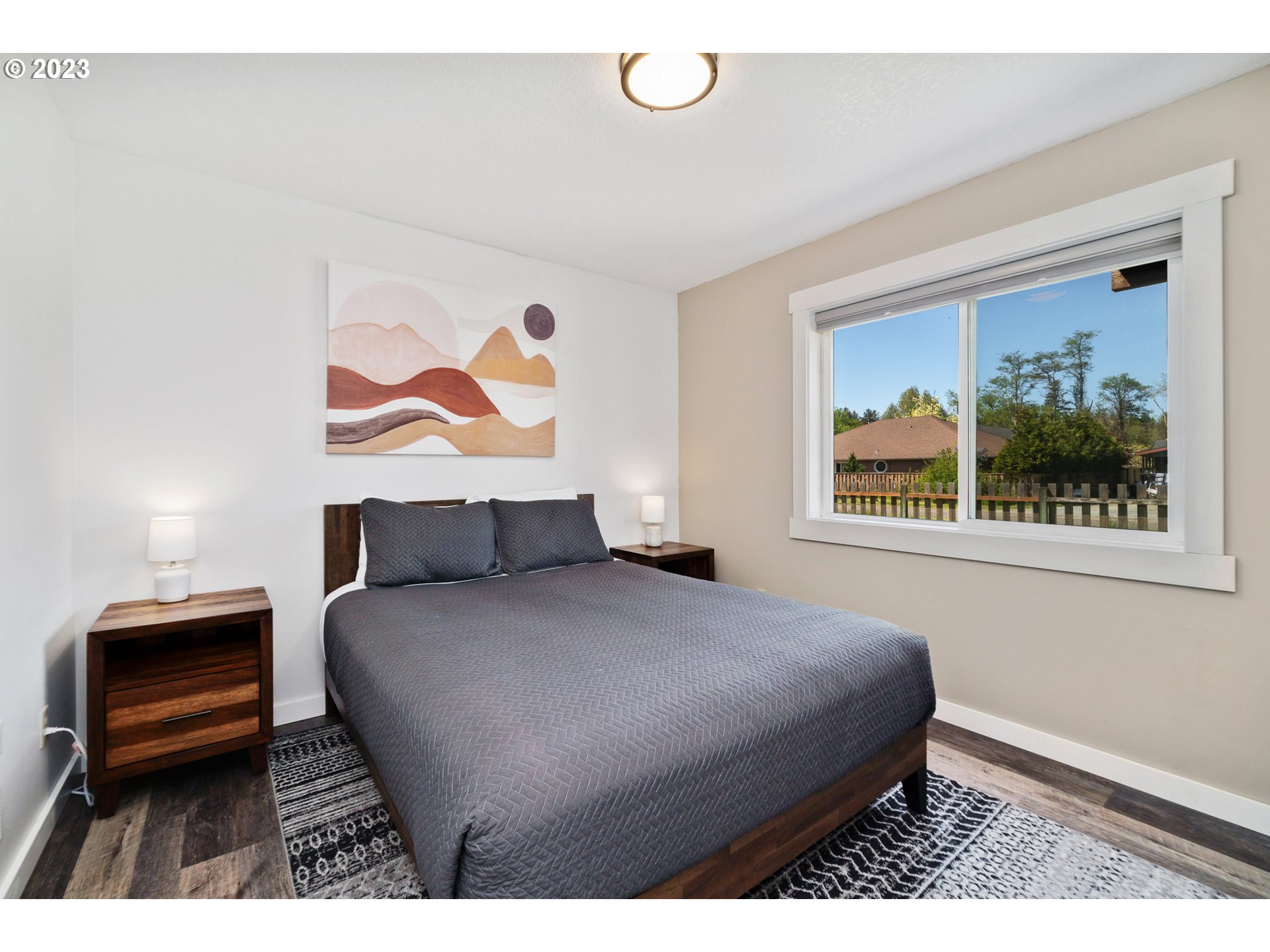 34010 Mallard Avenue Nehalem, OR 97131 - Photo 17 of 25 a bedroom with a bed and a painting on the wall