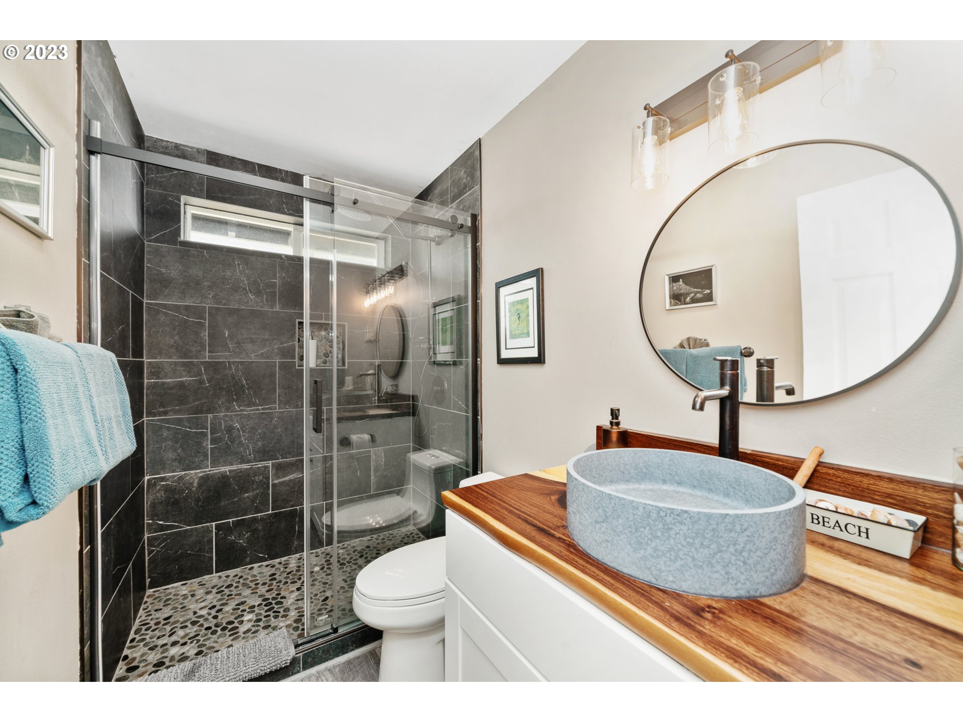 34010 Mallard Avenue Nehalem, OR 97131 - Photo 18 of 25 a bathroom with a sink a toilet and a mirror