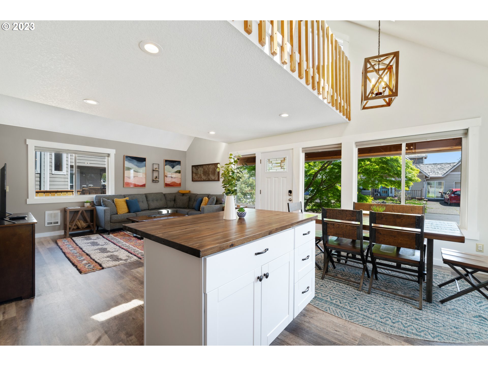 34010 Mallard Avenue Nehalem, OR 97131 - Photo 5 of 25 a kitchen with kitchen island granite countertop a table chairs sink and wooden floor