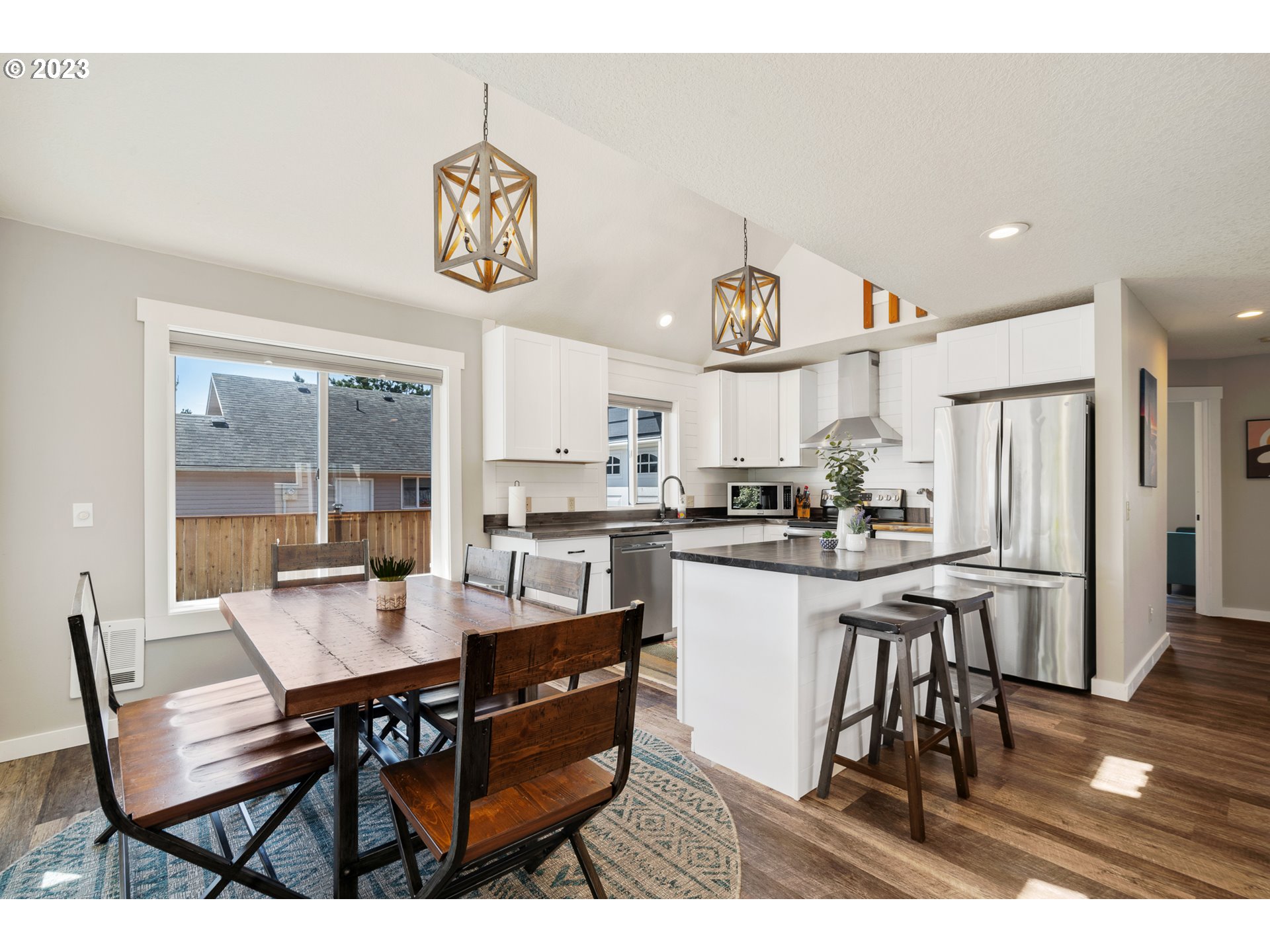 34010 Mallard Avenue Nehalem, OR 97131 - Photo 7 of 25 a kitchen with a dining table chairs and view living room