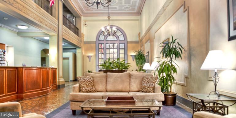 3900 Chestnut Street, Unit 0B729 Philadelphia, PA 19104 - Photo 2 of 13 a living room with furniture and a chandelier