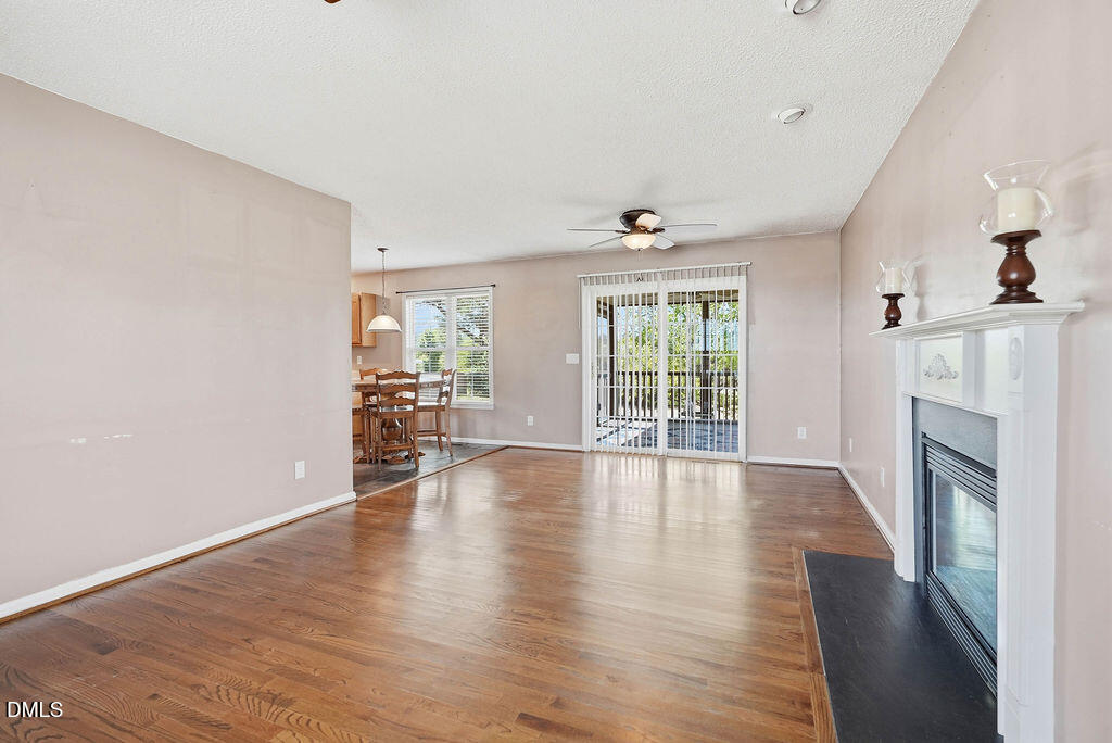1560 Cane Mill Road Coats, NC 27521 - Photo 12 of 32 wooden floor in an empty room with a fireplace