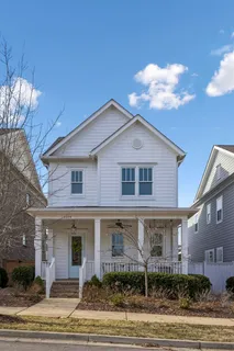 a kitchen with stainless steel appliances a refrigerator sink and white cabinets