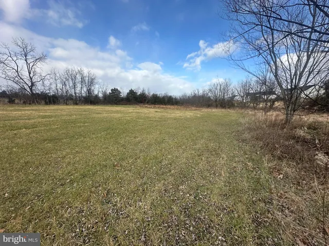 a view of a big yard with a barn