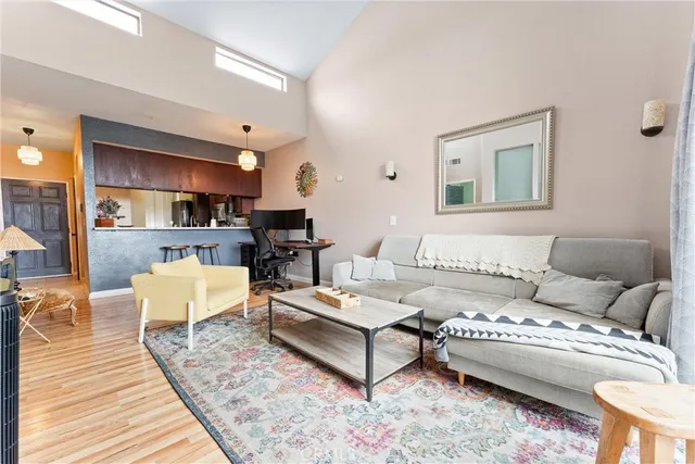 a view of a workspace with furniture and wooden floor