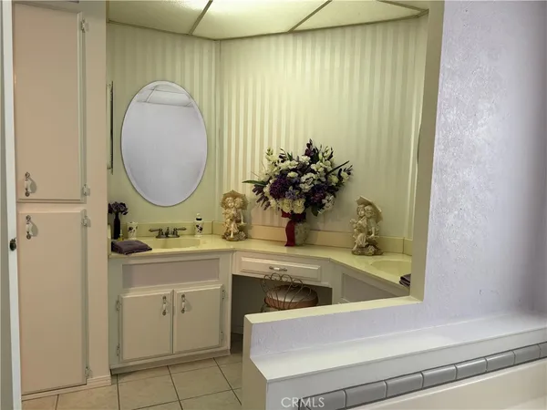 a bedroom with bed and a large mirror