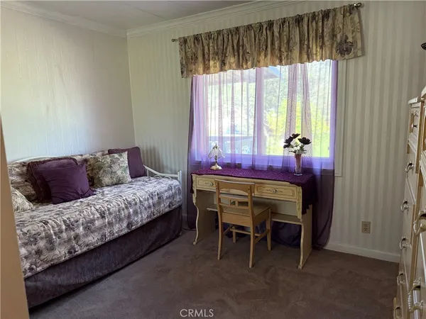 a view of a livingroom with a flat screen tv and furniture