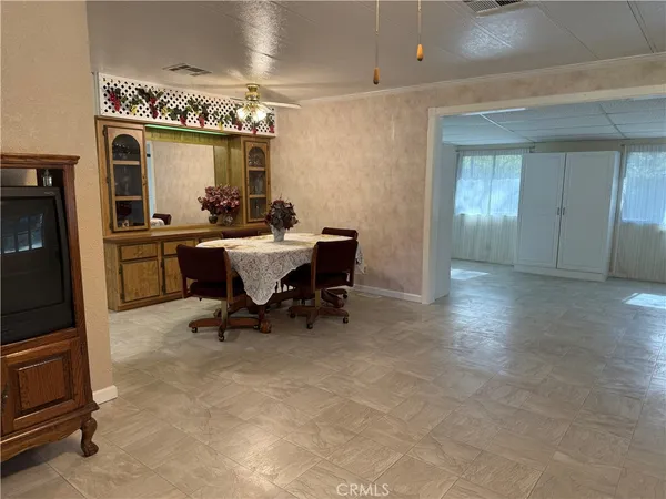 a dining room with furniture and window