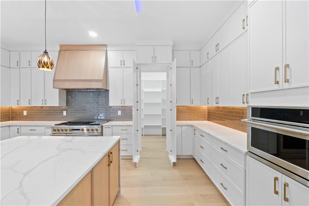 2709 Collins Hill Road Lawrenceville, GA 30043 - Photo 21 of 67 a kitchen with stainless steel appliances a stove sink and cabinets