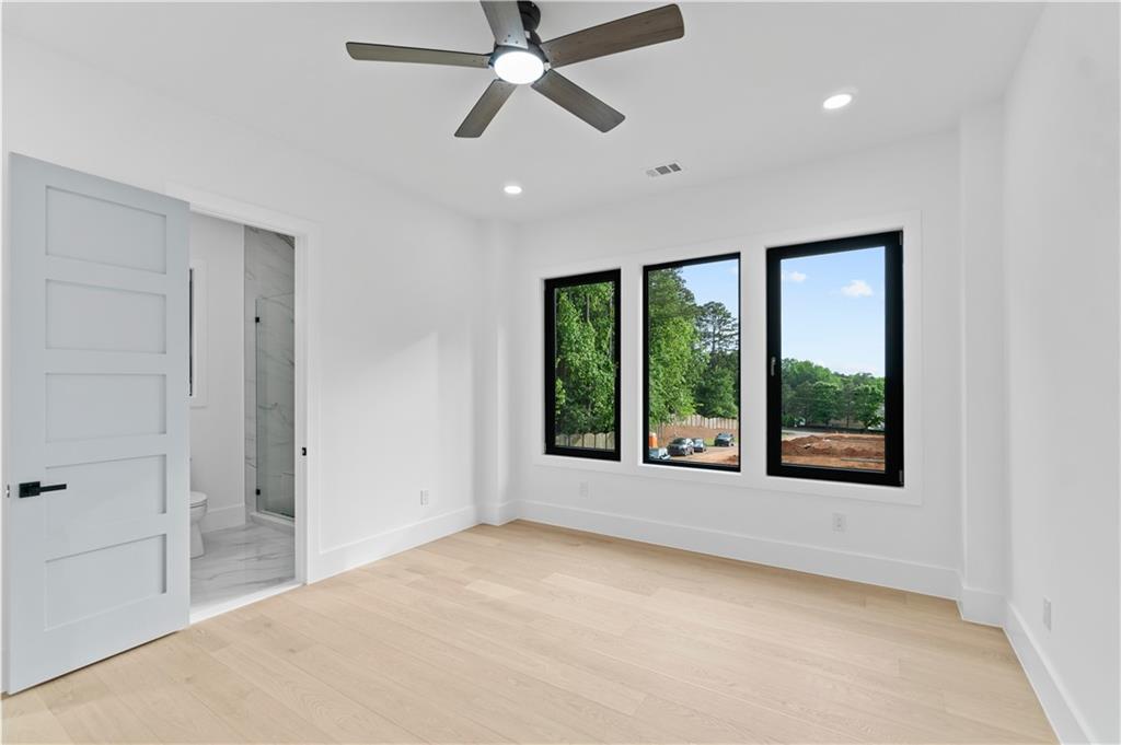 2709 Collins Hill Road Lawrenceville, GA 30043 - Photo 36 of 67 a view of an empty room with a window and a ceiling fan