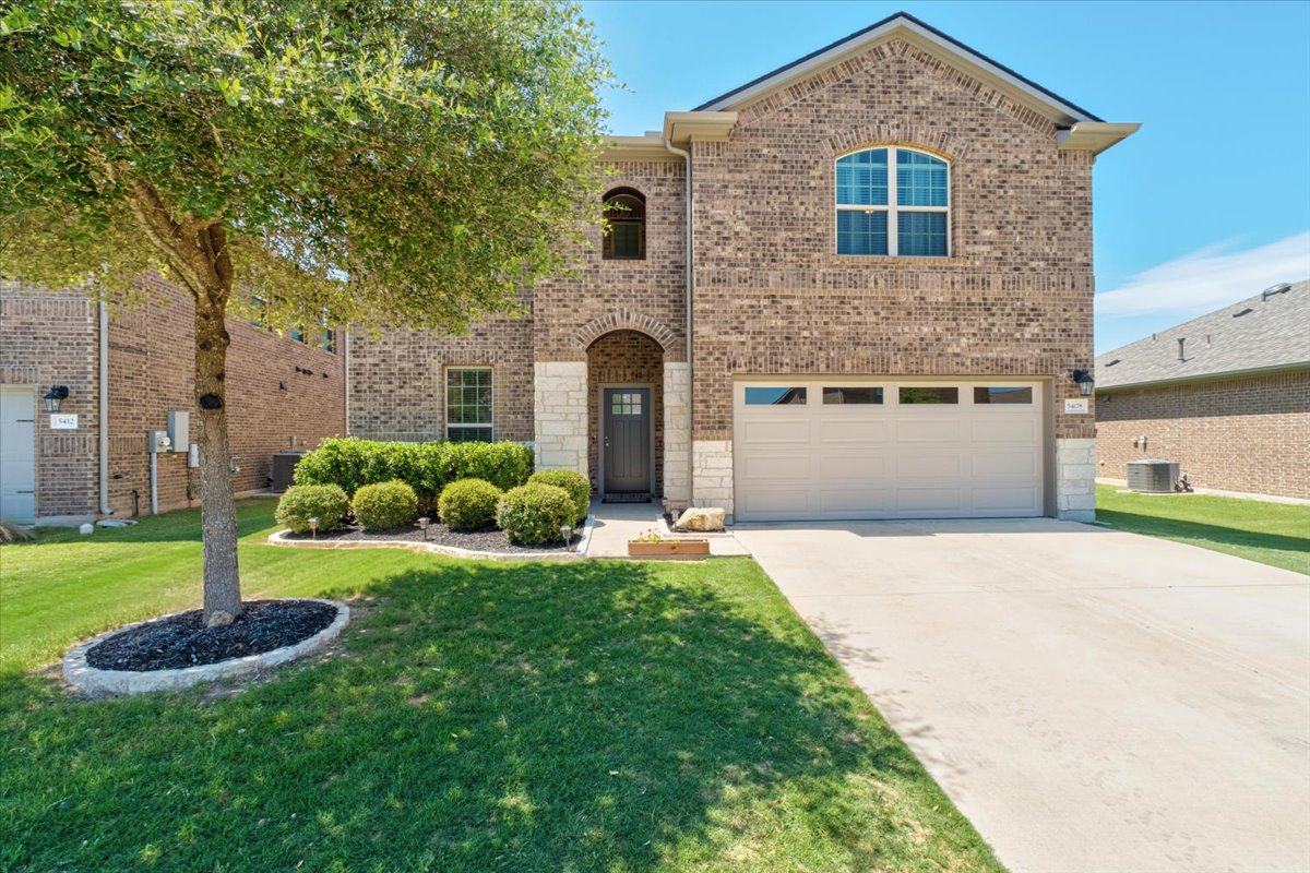 5408 Vanner Path Georgetown, TX 78626 - Photo 3 of 34 Brick facade residence featuring stone accents and an arched entry