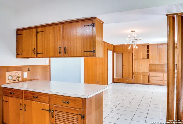 a kitchen with a sink a refrigerator and cabinets