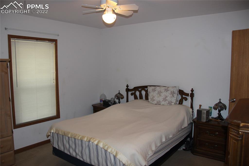 749 9th Street Calhan, CO 80808 - Photo 17 of 43 a bedroom with a bed and a chandelier