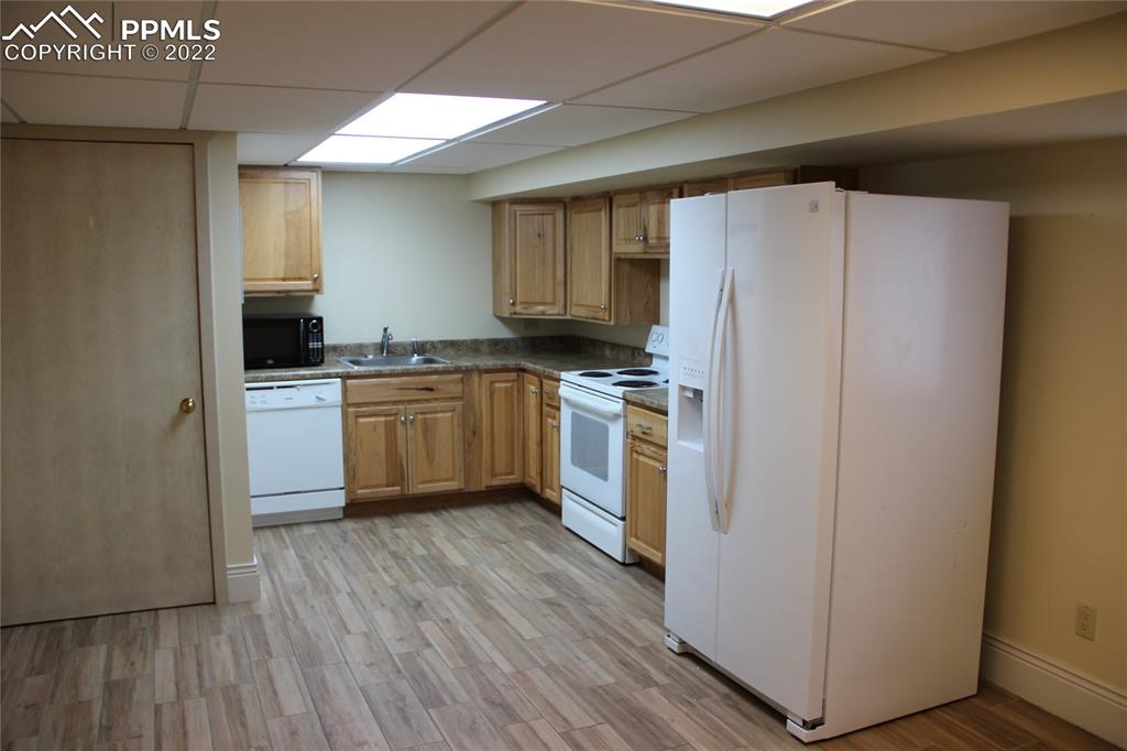 749 9th Street Calhan, CO 80808 - Photo 32 of 43 a kitchen with white cabinets and white appliances