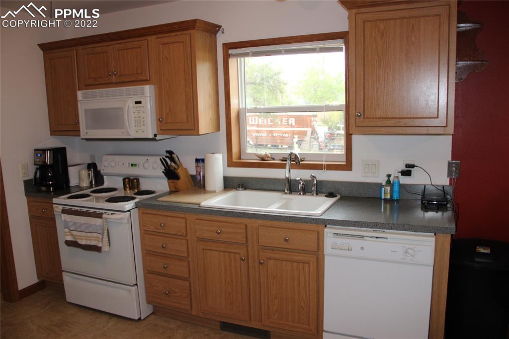 749 9th Street Calhan, CO 80808 - Photo 4 of 43 a kitchen with a sink stove and cabinets