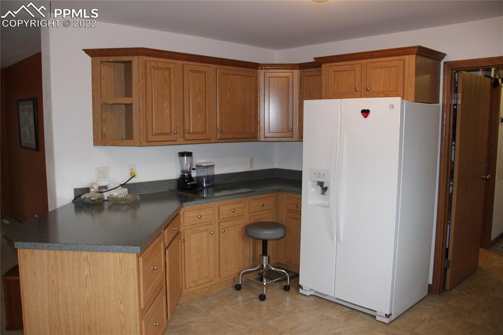 749 9th Street Calhan, CO 80808 - Photo 5 of 43 a kitchen with a refrigerator a sink and a stove